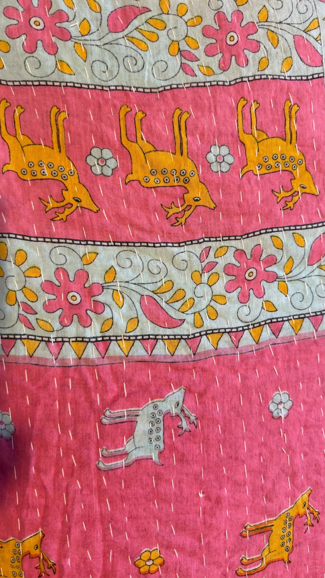 Pink Kantha cloth with rows of printed deer and floral vine borders, worked over with white running stitches